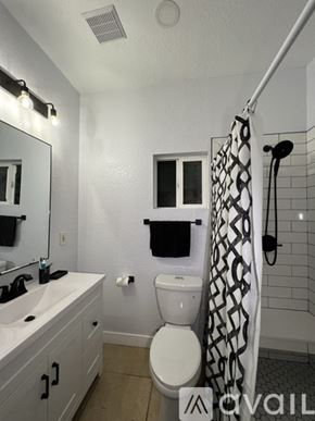 Hemet apartment for rent - A bathroom with a toilet, sink, and shower.