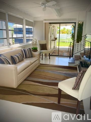 Key West apartment for rent - A living room with a white couch and a striped rug.