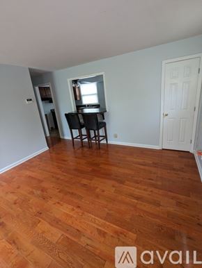 Nashville house for rent - A room with wooden flooring and a dining table with chairs.