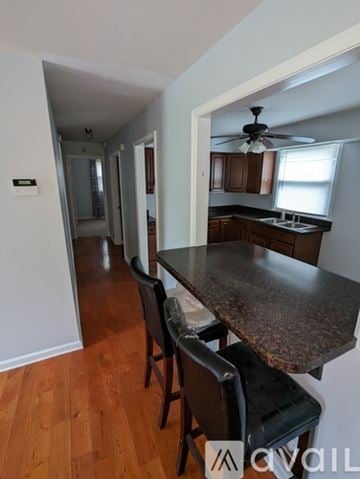 Nashville house for rent - A kitchen with a table and chairs in the foreground and a hallway in the background.
