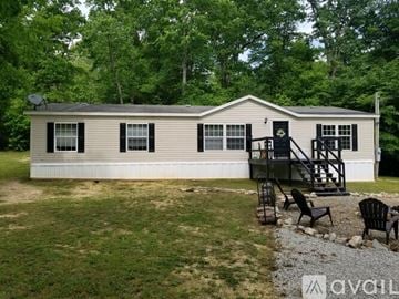Morehead house for rent - A mobile home with a deck and patio furniture.