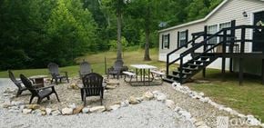 Morehead house for rent - A patio with a table and chairs is surrounded by a gravel area.