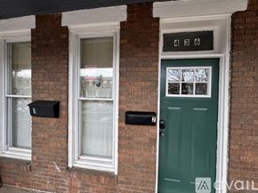 Baltimore apartment for rent - A house with a green door and mailboxes on the wall.