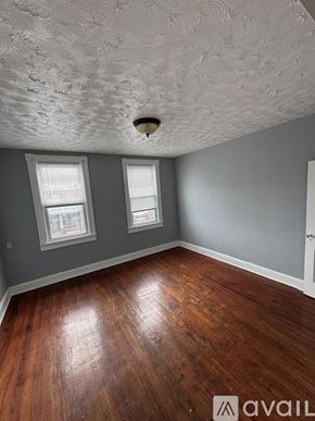 Baltimore apartment for rent - A room with wooden floors and a textured ceiling.