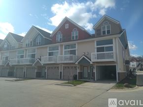 Waukesha apartment for rent - A row of houses with a sign that says "AVAIL" in front of them.