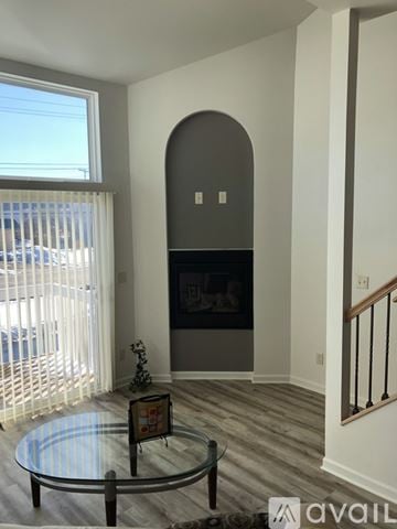 Waukesha apartment for rent - A living room with a glass table and a fireplace.