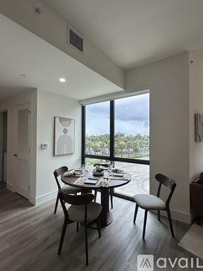 Oakland Park apartment for rent - A dining room with a table set for two and a view of the outside.