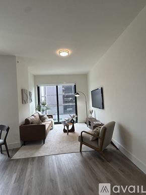 Oakland Park apartment for rent - A living room with a couch, chair, and television.