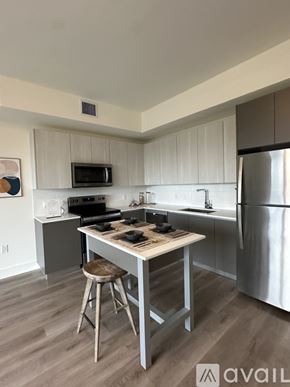 Oakland Park apartment for rent - A kitchen with a table and a refrigerator.