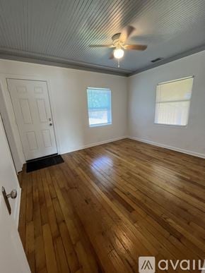 Tarpon Springs house for rent - A room with wooden flooring and a ceiling fan.