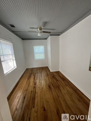 Tarpon Springs house for rent - A room with wooden floors and a ceiling fan.