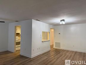 Port Charlotte apartment for rent - A room with wooden floors and a balcony with a railing.