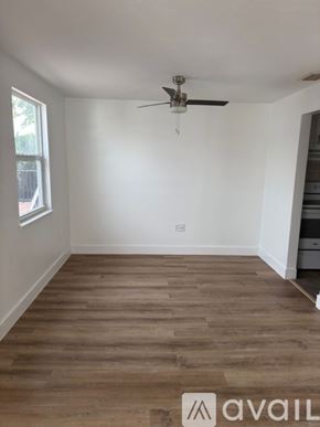 Port Charlotte apartment for rent - A room with a ceiling fan and wooden flooring.
