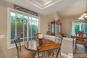 Huntington Beach house for rent - A dining room with a wooden table and chairs.
