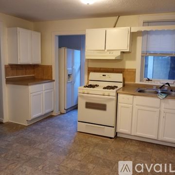Saint Paul apartment for rent - A kitchen with white cabinets and a stove top oven.