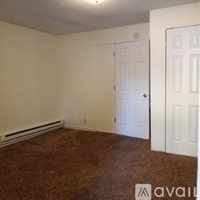 Saint Paul apartment for rent - A room with brown carpet and white walls.