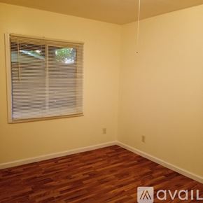 Saint Paul apartment for rent - A room with wooden flooring and a window with blinds.