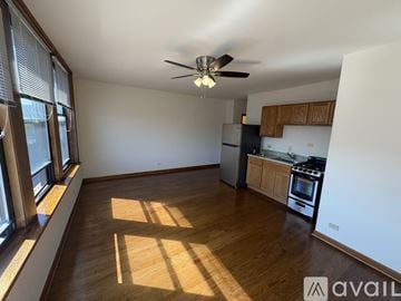 Chicago apartment for rent - A spacious kitchen with wooden floors and a ceiling fan.