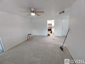 Ocala apartment for rent - A room with a ceiling fan and a broom is available for rent.