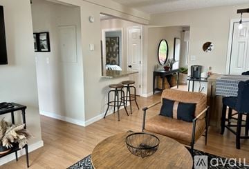 Laconia condo for rent - A living room with a brown leather chair and a wooden coffee table.
