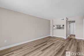 Fort Myers apartment for rent - A spacious room with wooden flooring and white walls.