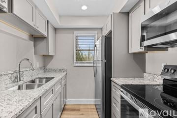 Fort Myers apartment for rent - A modern kitchen with granite countertops and stainless steel appliances.