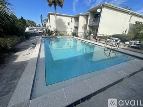 Fort Myers apartment for rent - A swimming pool in a residential area with a building in the background.