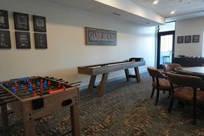 Garden City apartment for rent - A foosball table is in a room with a pool table and a sign that says "Game Room".