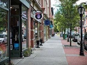 Beacon apartment for rent - A street with a sidewalk and a row of parked cars.