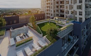 Kitchener apartment for rent - A rooftop patio with white chairs and a fire pit.