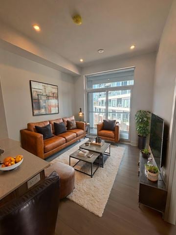 Kitchener apartment for rent - A living room with a brown couch and a coffee table.