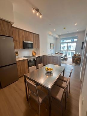 Kitchener apartment for rent - A modern kitchen with a dining table and chairs.