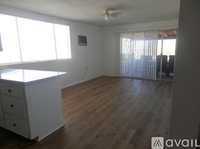 Landers apartment for rent - A room with wooden floors and a window with blinds.
