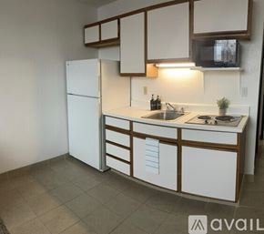 Bullhead City apartment for rent - A kitchen with white cabinets and a white refrigerator.
