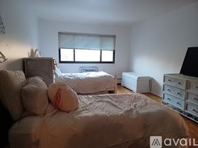 Piermont apartment for rent - A bedroom with a large bed and a window with blinds.