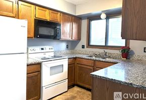 Eden Prairie house for rent - A kitchen with wooden cabinets and granite countertops.