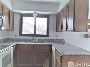 Eden Prairie house for rent - A kitchen with wooden cabinets and a granite countertop.