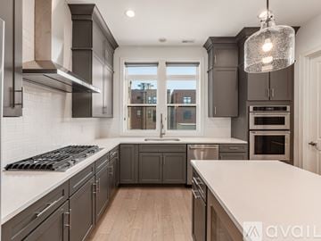 Columbus house for rent - A modern kitchen with dark grey cabinets and stainless steel appliances.