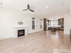 Columbus house for rent - A spacious living room with a fireplace and hardwood floors.