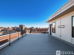 Columbus house for rent - A balcony with a railing and a building in the background.