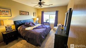 Appleton apartment for rent - A bedroom with a large bed and a ceiling fan.