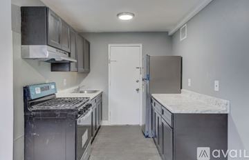Ewing Township apartment for rent - A kitchen with a stove top oven and a refrigerator.