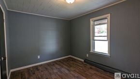 Mifflin house for rent - A room with a window and wooden floors.
