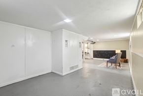 Bay Village house for rent - A spacious room with white walls and a grey floor.