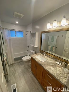 San Anselmo apartment for rent - A bathroom with a toilet, sink, and mirror.