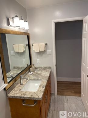 San Anselmo apartment for rent - A bathroom with a marble countertop and a large mirror.