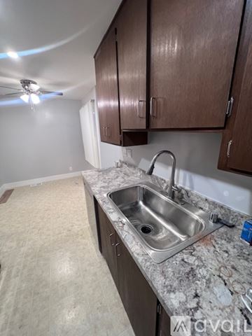 San Anselmo apartment for rent - A kitchen with a sink and brown cabinets.