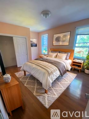 Boston apartment for rent - A bedroom with a bed, nightstand, and window.
