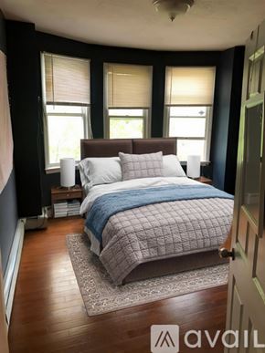 Boston apartment for rent - A bedroom with a bed, pillows, and a blanket.