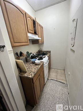 Boston apartment for rent - A kitchen with wooden cabinets and a granite countertop.